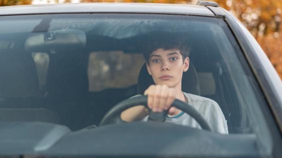 Teenage boy driving car