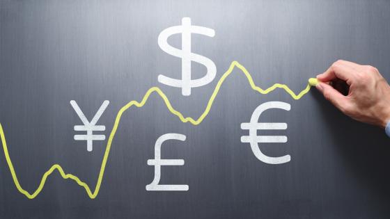 Drawing exchange rate graph with chalk on blackboard