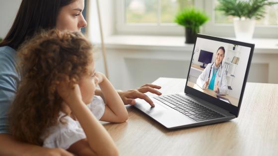 Mother and daughter in online consultation with doctor