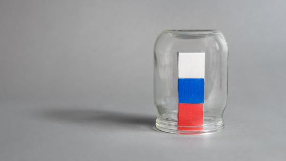 Cubes in the colour of Russian flag in an upside down jar