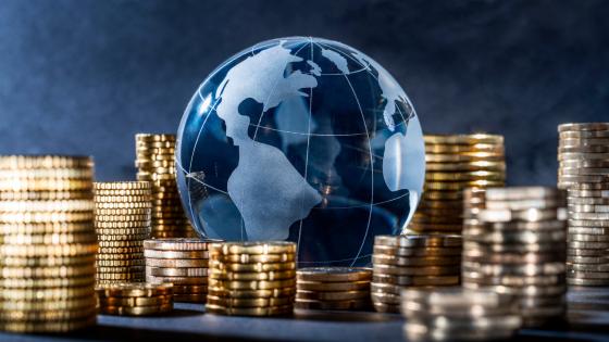 Glass globe with stacks of coins