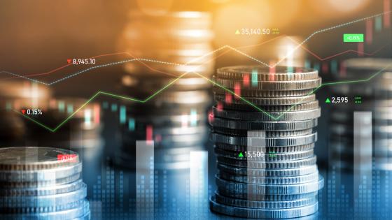 Stacks of coins and financial charts